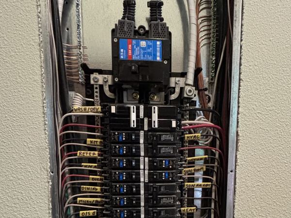 Residential electrical panel in Gig Harbor with the cover removed, circuits dressed and labelled