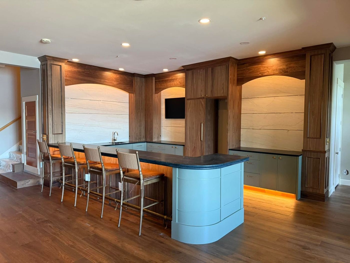 Finished Lakewood kitchen with recessed ceiling lighting, lit cabinetry and a seated island