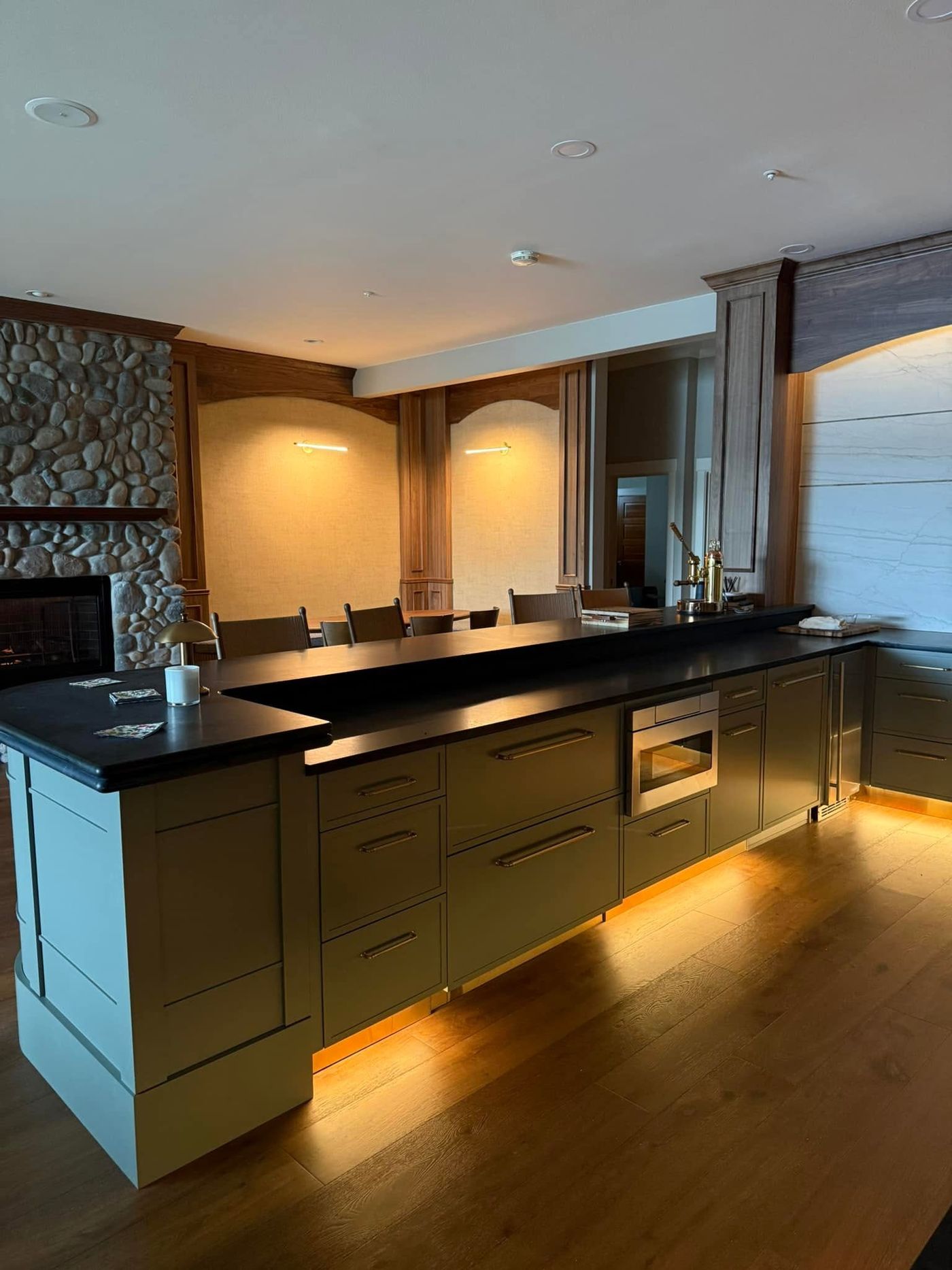 Lakewood kitchen at night with under-cabinet lighting and a lit island