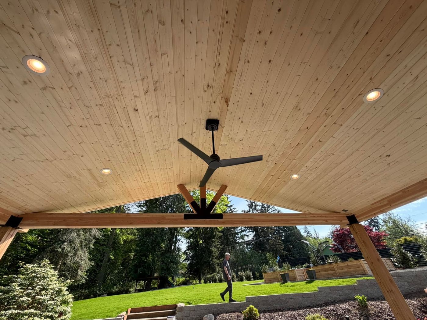 Cedar-lined covered patio ceiling in Kingston with recessed lighting and a large ceiling fan